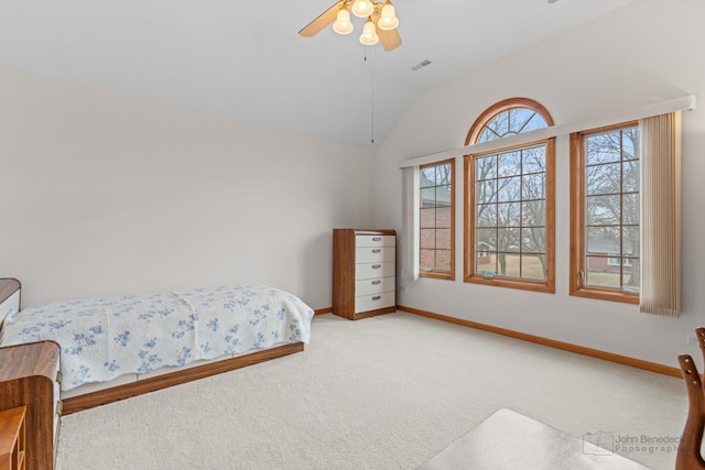 carpeted bedroom with lofted ceiling, ceiling fan, visible vents, and baseboards