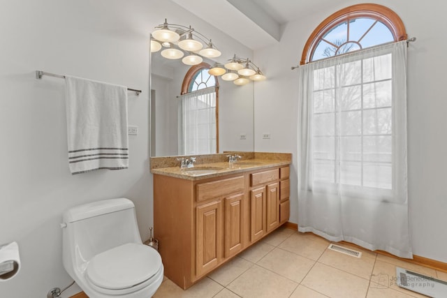 bathroom with toilet, visible vents, a sink, and tile patterned floors