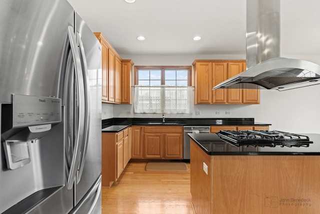 kitchen with island exhaust hood, recessed lighting, appliances with stainless steel finishes, light wood-style floors, and a sink