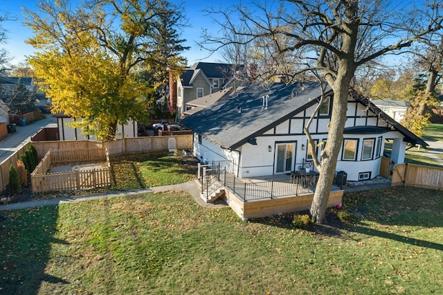 back of property featuring stucco siding, a fenced backyard, and a yard