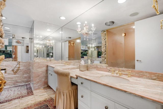 full bath with an inviting chandelier, recessed lighting, and vanity