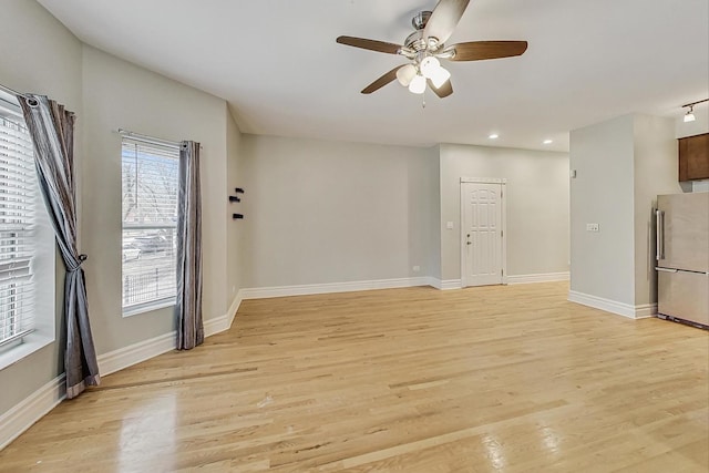 unfurnished living room featuring baseboards, recessed lighting, a ceiling fan, and light wood-style floors