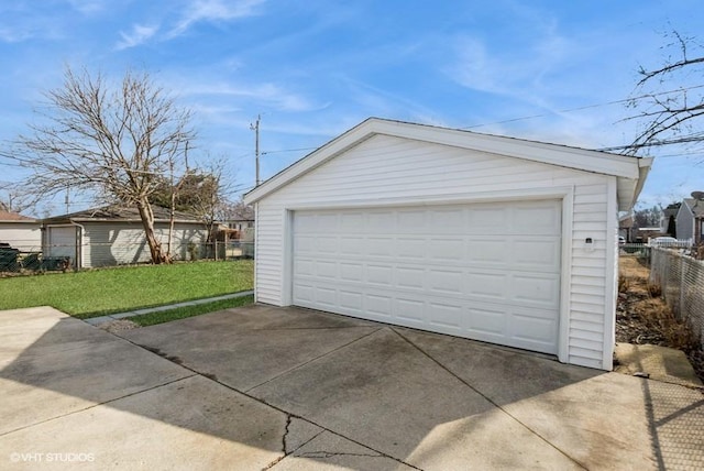 detached garage featuring fence