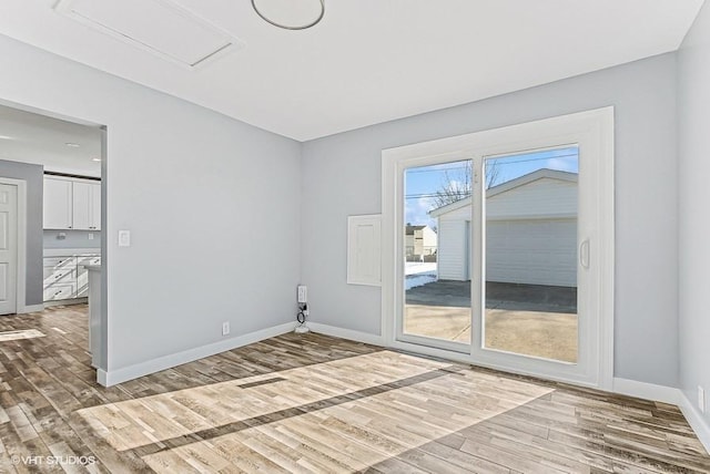 unfurnished room featuring wood finished floors and baseboards