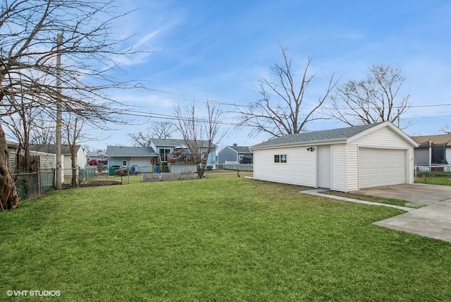 view of yard with a fenced backyard, an outdoor structure, and a detached garage