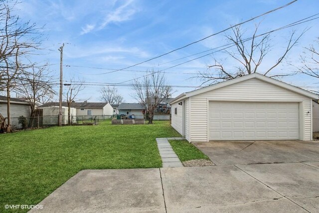 view of yard featuring a garage, an outdoor structure, and fence