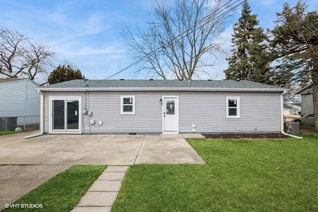 rear view of property with roof with shingles, a patio area, a yard, and fence