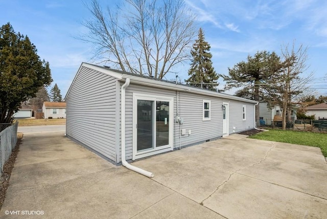 rear view of property featuring a patio area and fence