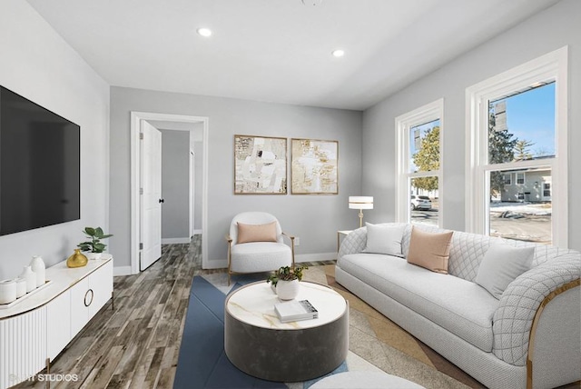 living room featuring recessed lighting, baseboards, and wood finished floors