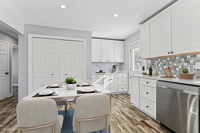 interior space with white cabinetry, light wood finished floors, and stainless steel dishwasher