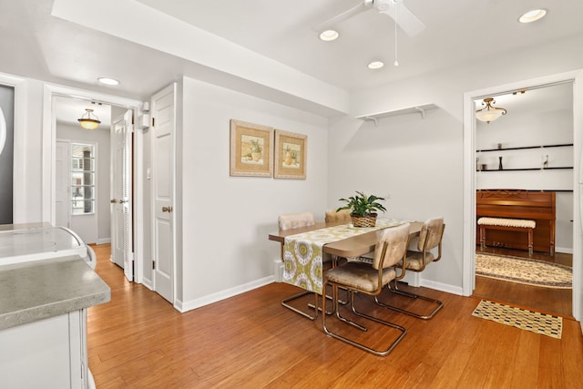 dining space featuring light wood-style floors, baseboards, a ceiling fan, and recessed lighting