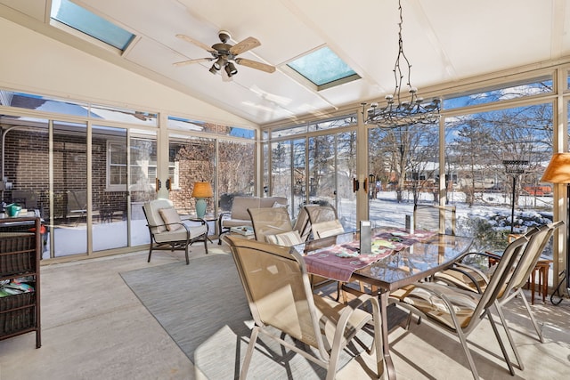 sunroom with vaulted ceiling with skylight, a ceiling fan, and a healthy amount of sunlight