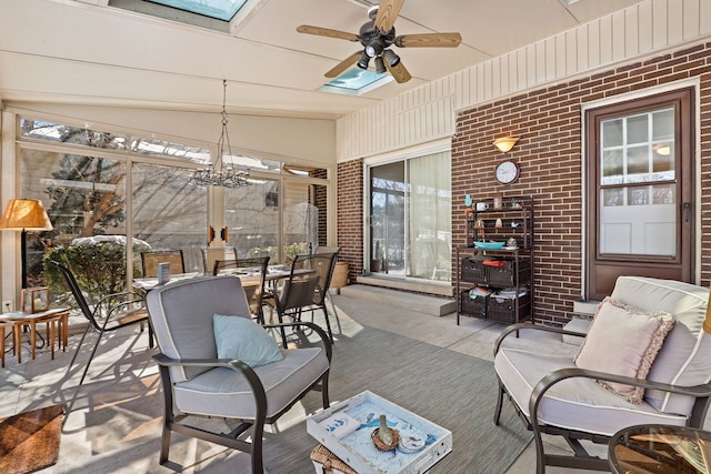 sunroom / solarium featuring a skylight and a ceiling fan