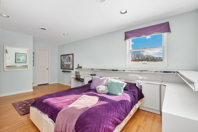 bedroom featuring baseboards, wood finished floors, visible vents, and recessed lighting