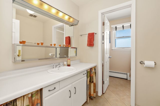 bathroom featuring a baseboard heating unit, visible vents, vanity, and tile patterned floors