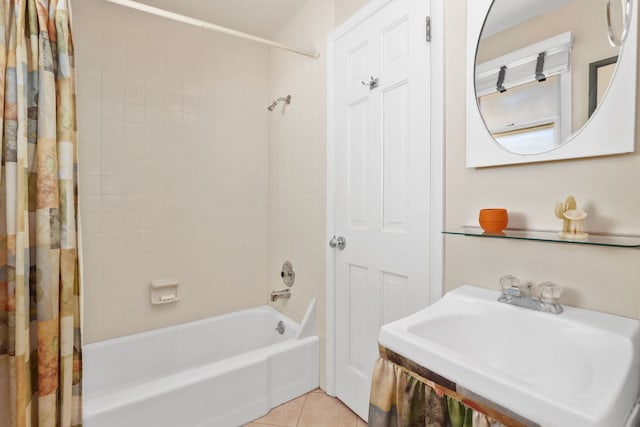 full bathroom with tile patterned flooring, shower / bath combo with shower curtain, and a sink