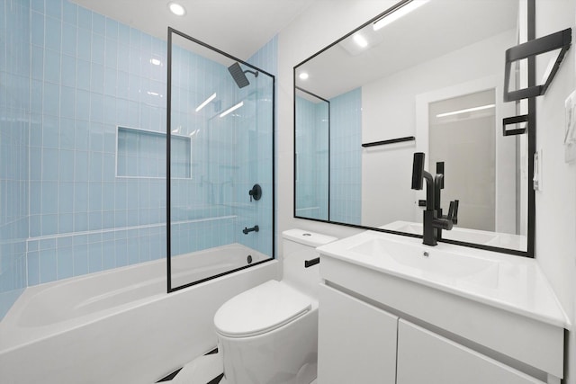 bathroom featuring washtub / shower combination, toilet, vanity, and recessed lighting