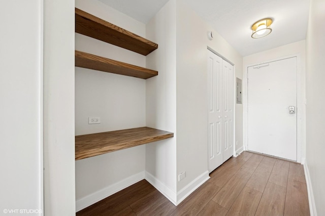 interior space with baseboards and light wood finished floors