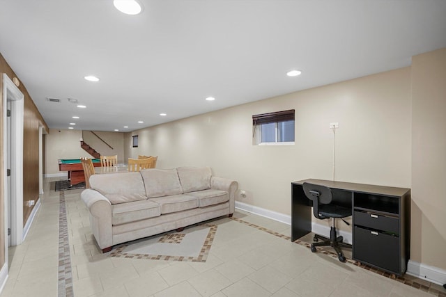 living area with recessed lighting, visible vents, and baseboards