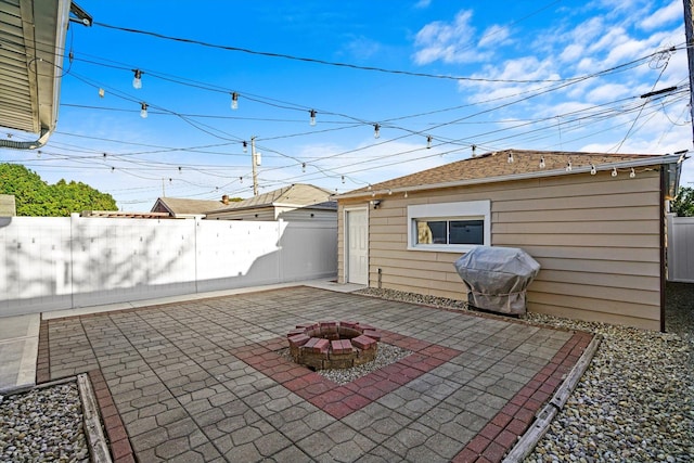 view of patio / terrace with a fenced backyard, a grill, and a fire pit