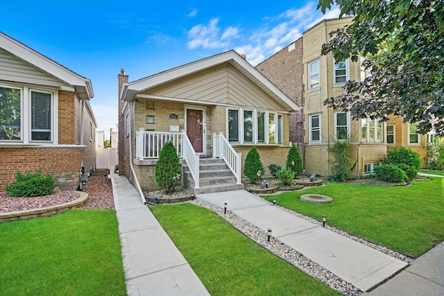 view of front of home with brick siding and a front lawn