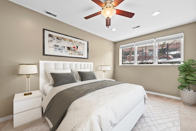 bedroom with light colored carpet, visible vents, baseboards, and recessed lighting