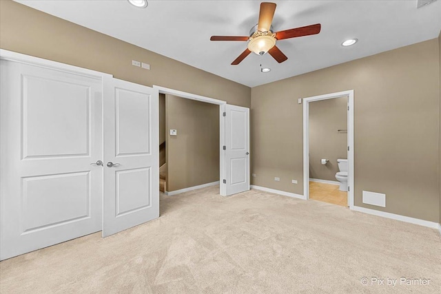 unfurnished bedroom featuring recessed lighting, ensuite bathroom, a ceiling fan, light carpet, and baseboards