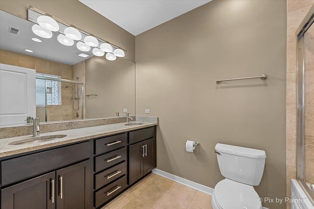 bathroom featuring double vanity, a stall shower, visible vents, and a sink