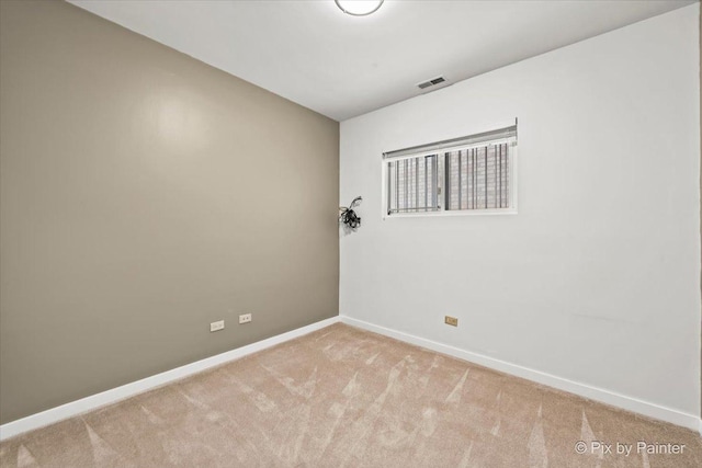 unfurnished room featuring visible vents, light carpet, and baseboards