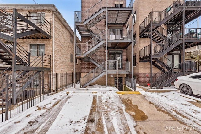 exterior space with brick siding and stairs