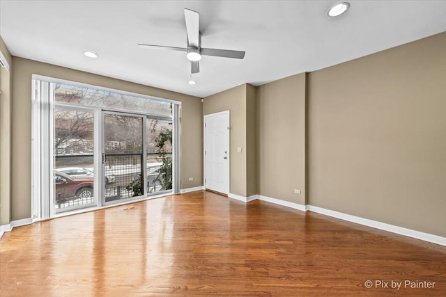 empty room with ceiling fan, recessed lighting, wood finished floors, and baseboards