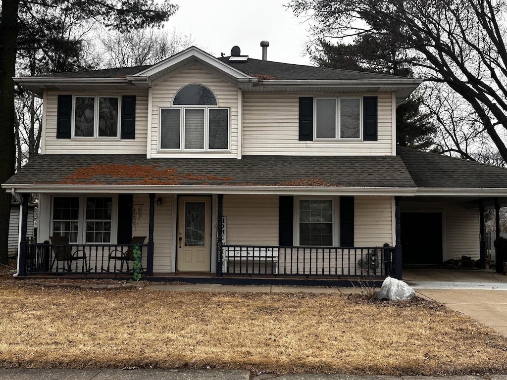 view of front of home featuring a porch, concrete driveway, and roof with shingles