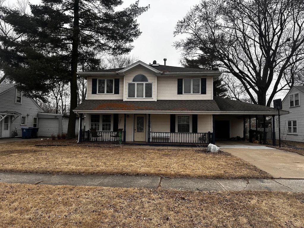 view of front facade with driveway and a porch