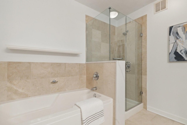 bathroom featuring a stall shower, visible vents, a garden tub, and tile patterned floors