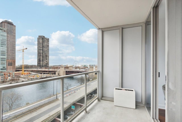 balcony with a view of city and a water view