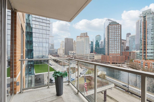 balcony featuring a city view and a water view