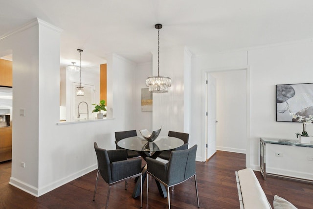 dining space with a notable chandelier, ornamental molding, dark wood finished floors, and baseboards