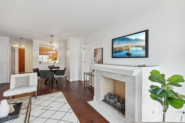 living room with baseboards, a premium fireplace, and wood finished floors