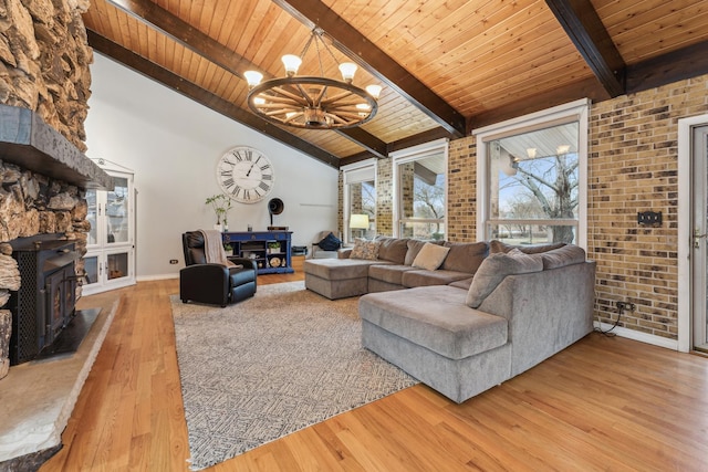 26980 N Pierre Dr, Mundelein, IL 60060 - living room with a wooden ceiling with exposed beams, wood finished floors, a chandelier, a wood stove, and high vaulted ceiling