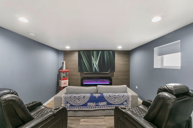 cinema room with baseboards, wood finished floors, and recessed lighting