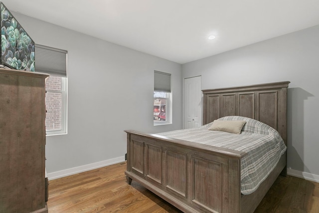 bedroom featuring light wood-style flooring and baseboards