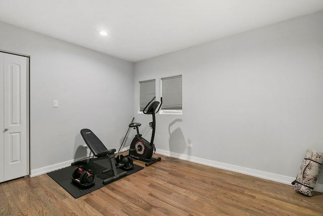 exercise area featuring recessed lighting, baseboards, and wood finished floors