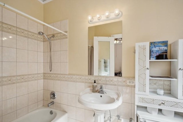 full bath with backsplash, tub / shower combination, and a sink