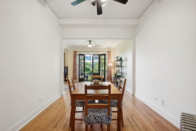 dining room with ceiling fan, radiator heating unit, light wood-style flooring, and baseboards