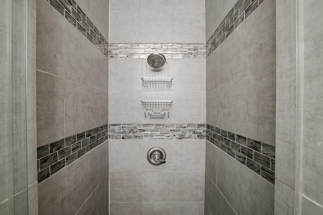 bathroom with a tile shower