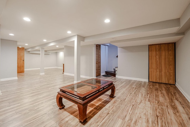 living area featuring baseboards, stairway, recessed lighting, and light wood-style floors