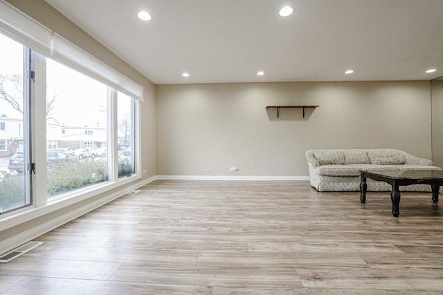 sitting room featuring light wood finished floors, visible vents, and recessed lighting