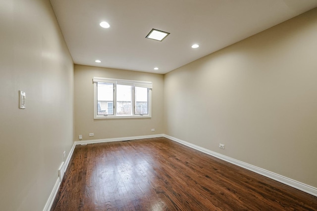 unfurnished room featuring dark wood-style floors, recessed lighting, and baseboards