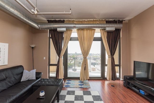 living room with expansive windows and wood finished floors