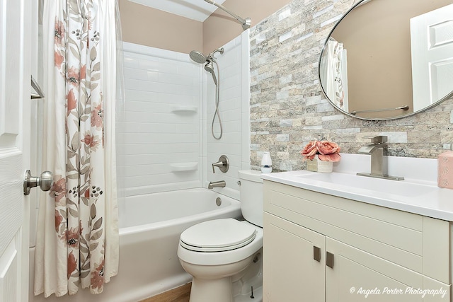 bathroom with vanity, shower / bath combo with shower curtain, and toilet